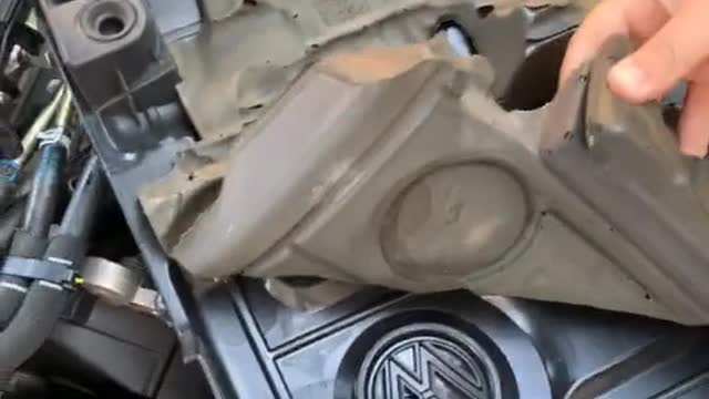 Open the engine cover and repair the car with an unexpected logo.