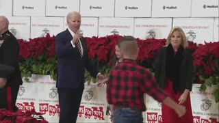 A child escorts Biden offstage