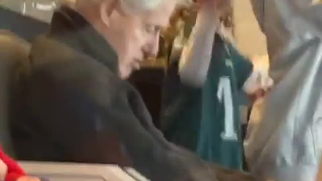 Bill Clinton slipping in the middle of the game between Eagles and Giants