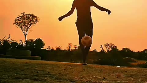 Guy Performs Astounding Football Tricks in Scenic Backdrop During Sunset