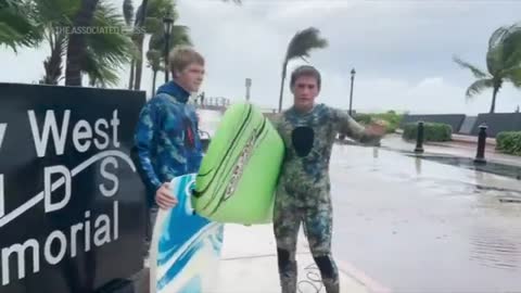 Florida surfers catch waves as Hurricane Ian nears