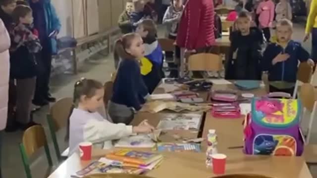 Ukrainian children sing the Ukrainian anthem in a bomb shelter during the Russian attacks on Kyiv