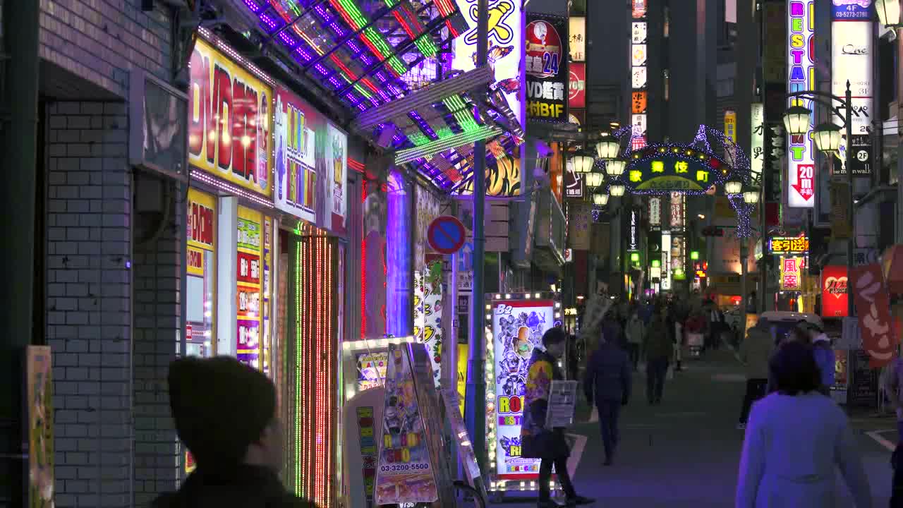 Flashing Neon Signs on Japanese Street at Night