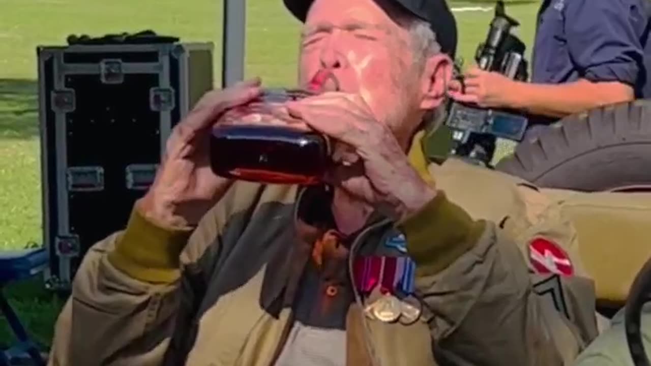 WWII Veteran Reid Clanton takes a big swig of vintage whiskey in the Quadrangle at Fort Sam Houston.