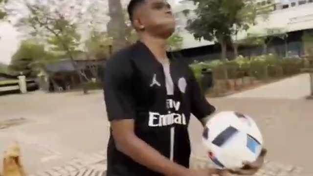 Man Performs Tricks with Football by Balancing it on His Head and Shoulders