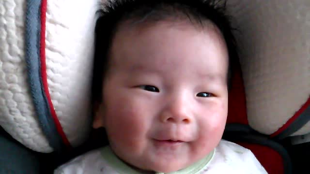 Cute infant baby loves to listen to Jesus in the Bible