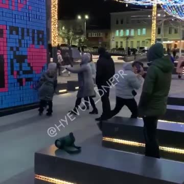 Dnipro, Ukraine: Man dances to songs in front of wall with swastika