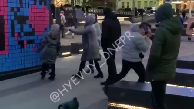 Dnipro, Ukraine: Man dances to songs in front of wall with swastika