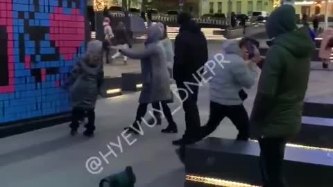 Dnipro, Ukraine: Man dances to songs in front of wall with swastika