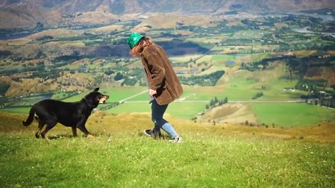 Girl Playing With Dog In The Grass