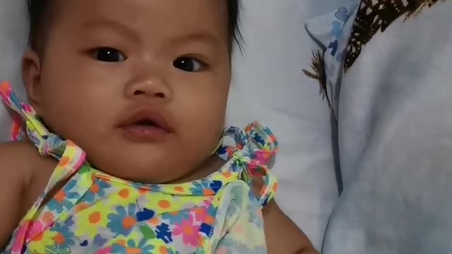 Cute baby wants to eat her feet