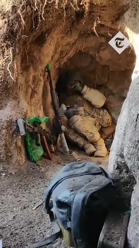 Ukrainian soldiers barely avoid Russian bomb as they hide in a trench.