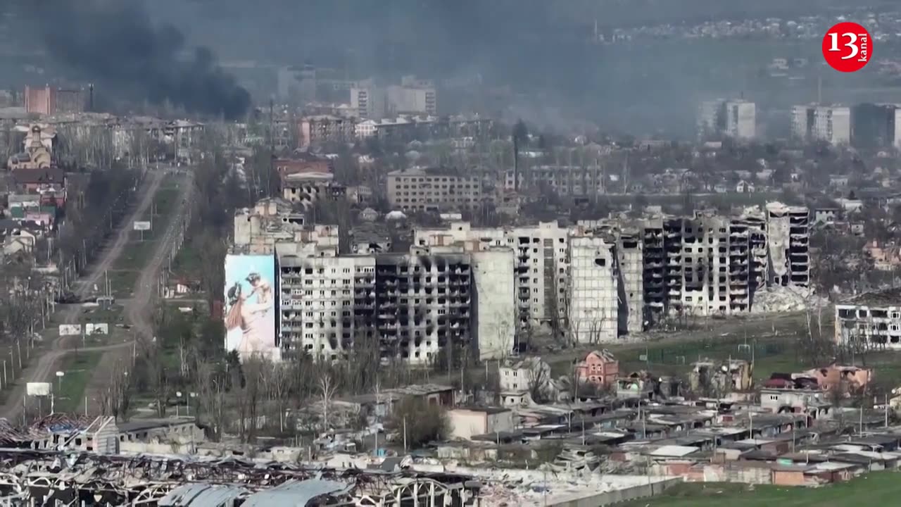 Drone shows smoke rising among destroyed buildings in Bakhmut