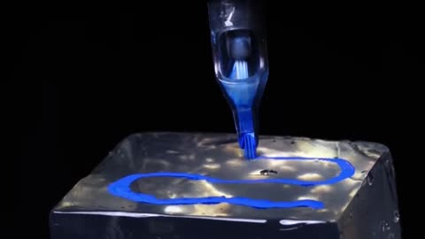 The needles of a tattoo machine injecting ink into ballistic gel