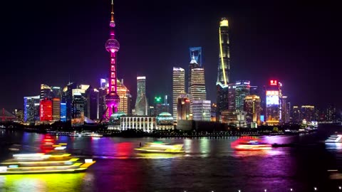 Shanghai river and illuminated city buildings