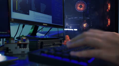 Hands of a programmer working on his computer
