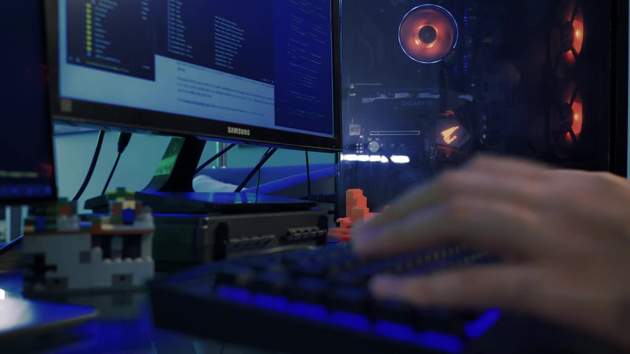 Hands of a programmer working on his computer