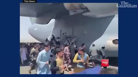 Afghans climb on to plane during takeoff in attempt to flee Taliban