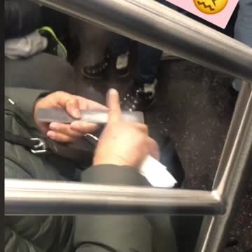 Woman files her index finger with nail filer on subway train