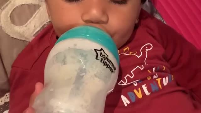 Funny beby drinking milk while sleeping