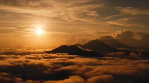 Drone Footage of Mountain Peaks in a Sea of Clouds