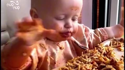 Funny baby eating spagety