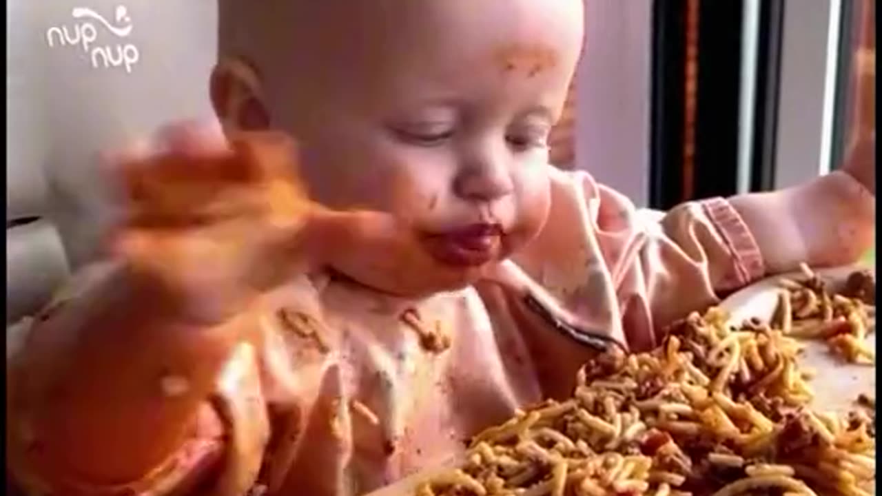 Funny baby eating spagety