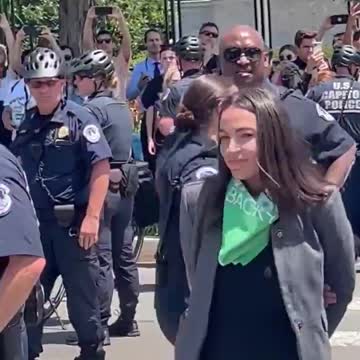 AOC was just escorted by police away from the Supreme Court.