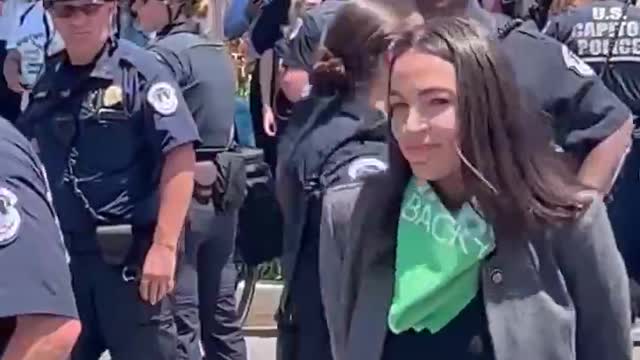 AOC was just escorted by police away from the Supreme Court.