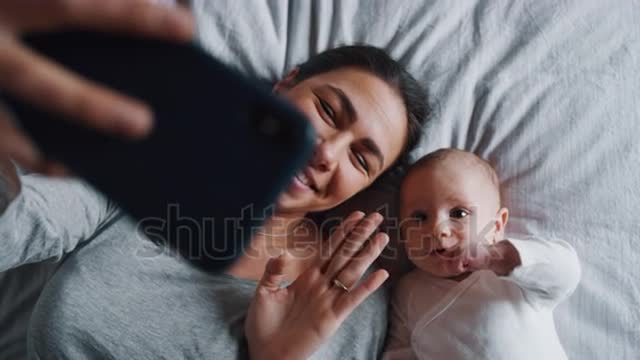 neo mother and her newborn baby making a selfie