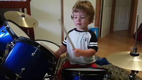 A young 2 year old toddler drummer