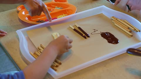 The hand of a child making chocolate cookies at home