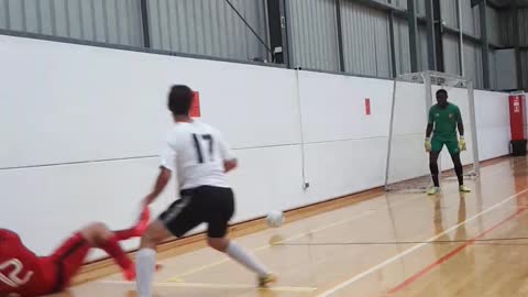 Soccer player in red hits wall