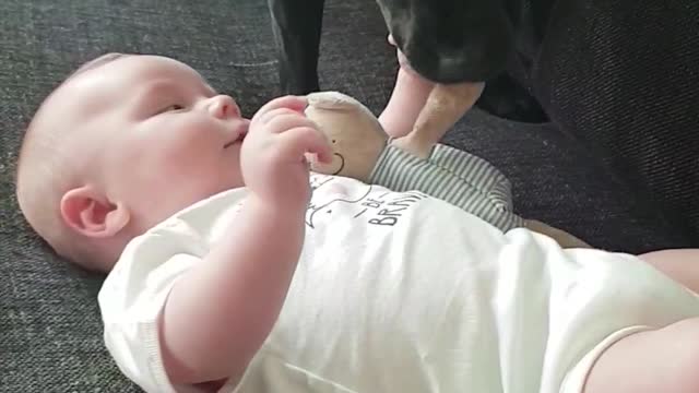 Stina gently gives her toy to her littlebrother