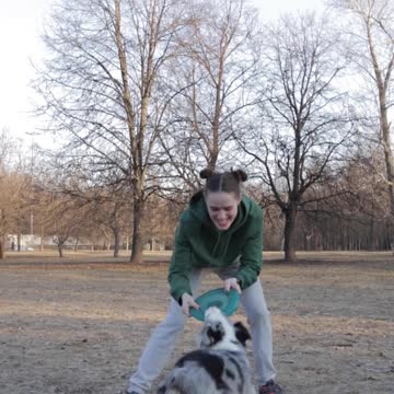 A Woman Playing with Her Dog
