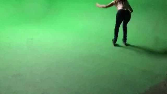 Girl in white shirt roller skating falls down