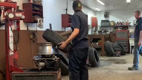 Mechanic Teaches Buddy How to Put the Tire on Quick