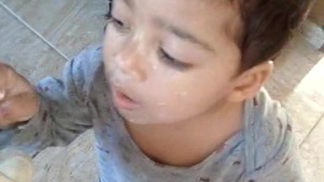 Miguel putting sunscreen on the doll