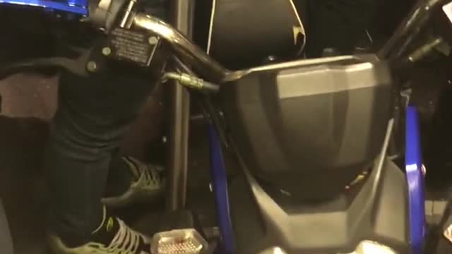 Guy brings blue motorcycle into subway