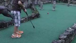 Kid impossibly sinks crazy mini golf shot