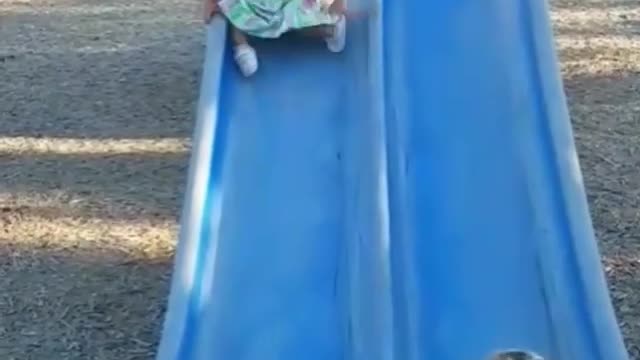 Collab copyright protection - baby girl tumbles down blue slide