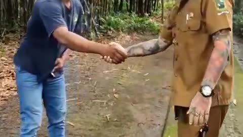 pak lurah handshake with a tattoo on his snake hand