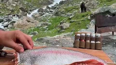 Fish cooking in professiinal style by river side