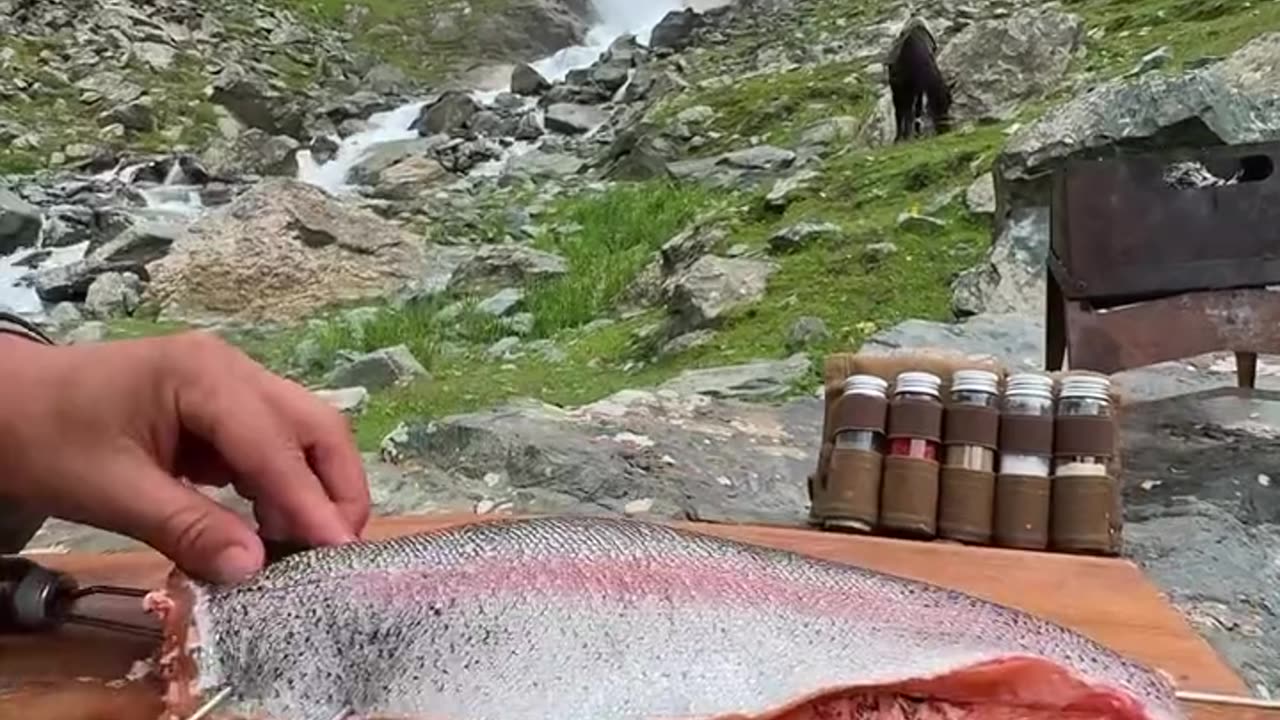 Fish cooking in professiinal style by river side