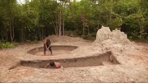 Underground hut with a grass roof and a swimming