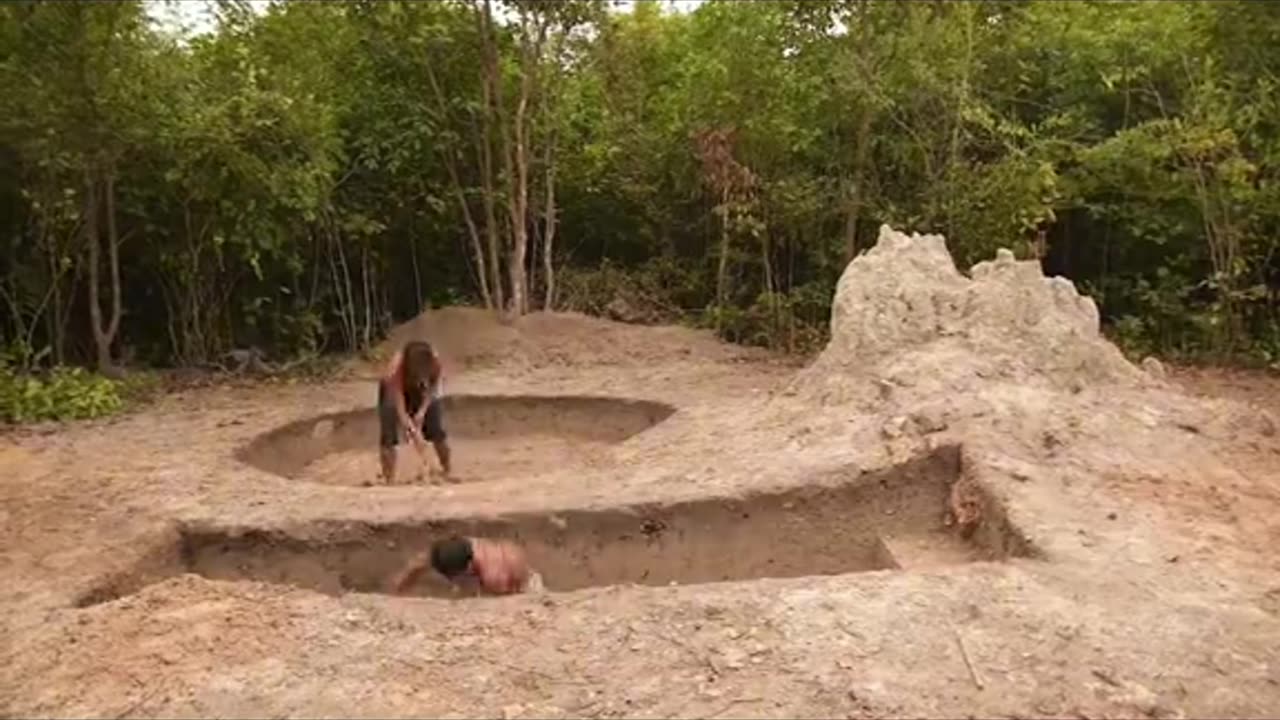 Underground hut with a grass roof and a swimming