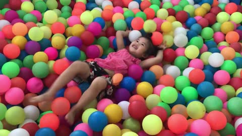 Children playing with colouring balls