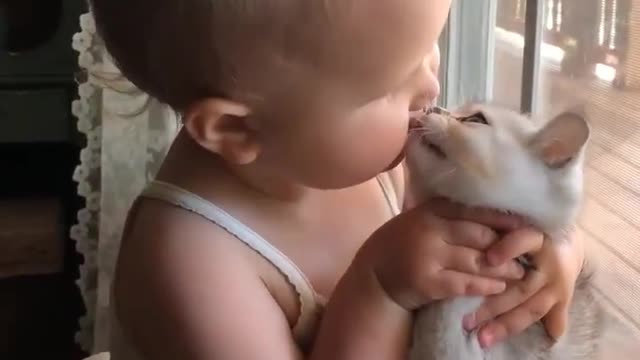 My girl adorably kisses her cute little cat <3