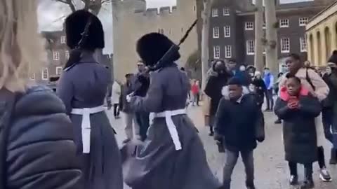 British Coldstream Guard soldier stepping on a child’s foot during a patrol march