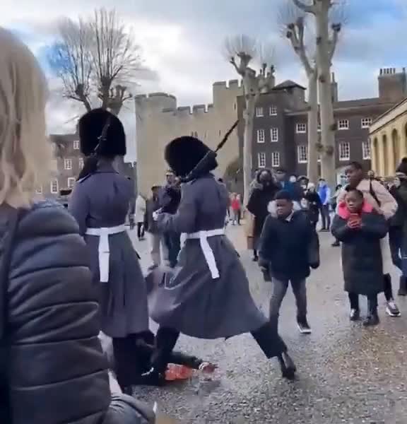 British Coldstream Guard soldier stepping on a child’s foot during a patrol march